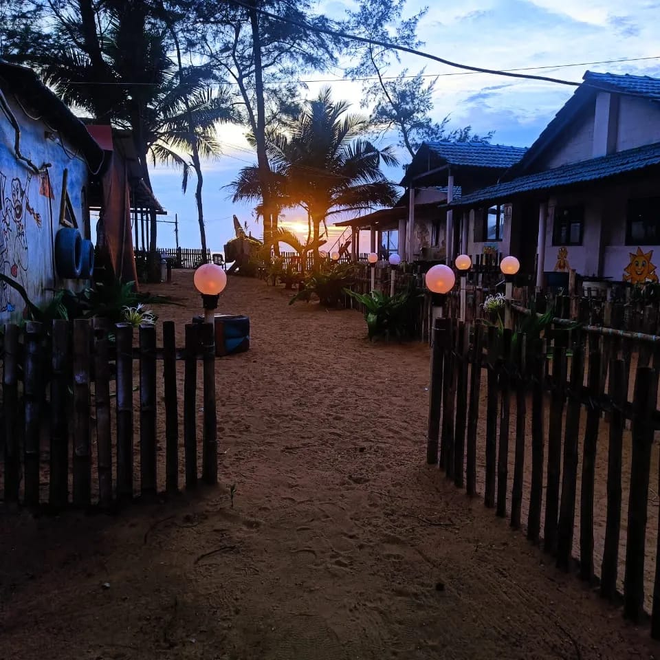 Beachside hammocks and lanterns at dusk